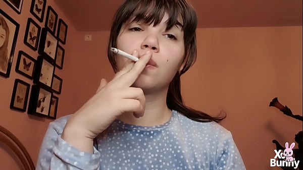 Big lips covered in lipgloss smoking with close up of the lips