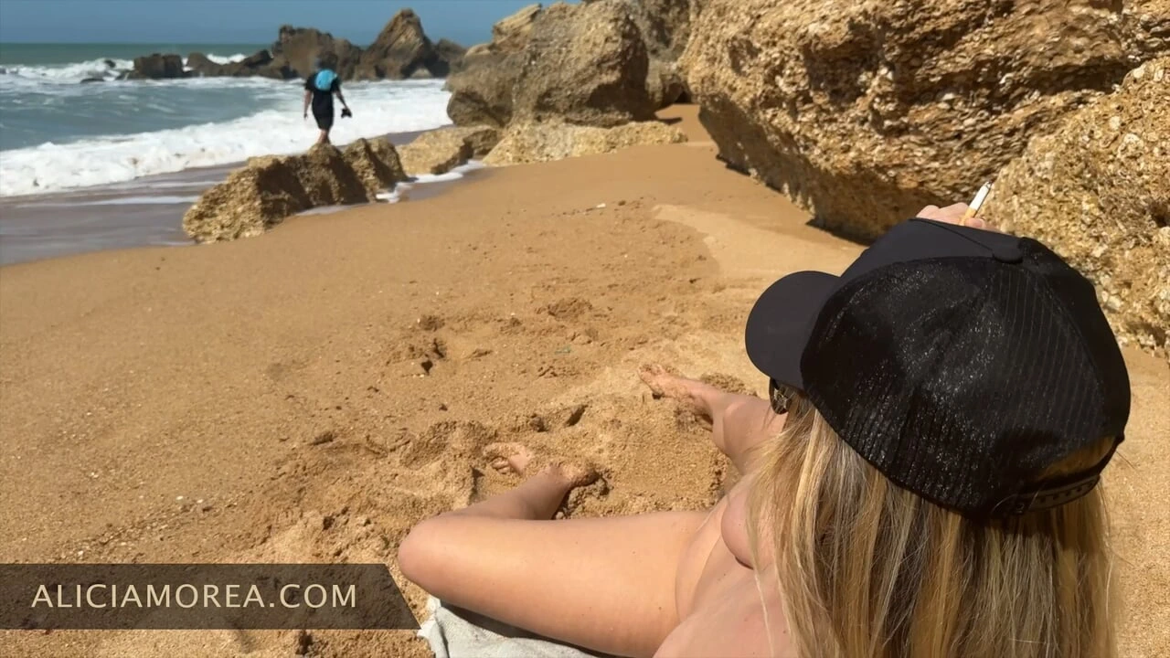 blonde with big natural boobs smokes naked on the public beach