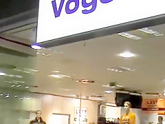 Busty wife gives her man a nice blowjob in a changing room at the mall